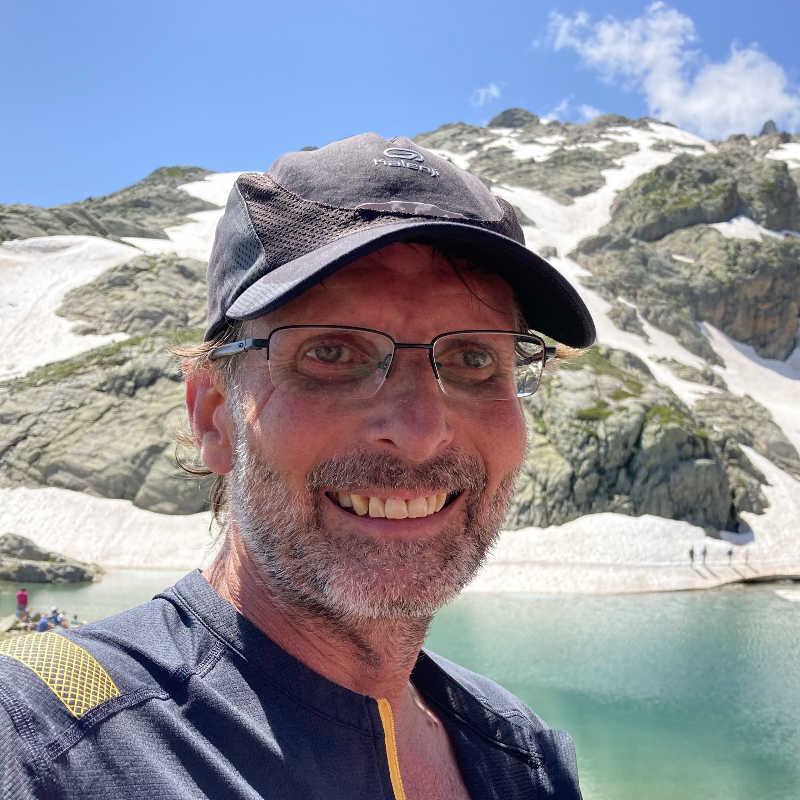 Portrait of Mark Priestley in front of a mountain.